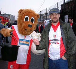 Yorkie the lion, club mascot, and a Friend of Bootham Crescent, Nov 2002 bucket collection for the Trust. Photo credit: Daley