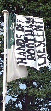 The flag on here used to say something about togetherness and building a home. Our own flag reminds them what we think about them wanting to build on ours. Photo: Daley
